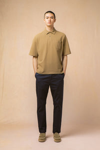 A model wearing a polo shirt and trousers from Scottish menswear designer KESTIN.