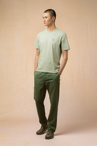 A model wearing trousers and a tee from menswear brand KESTIN.