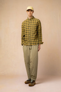 A model wearing a check shirt and relaxed fit trousers from KESTIN.