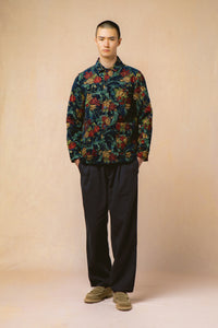 A model wearing a floral jacqaurd jacket and navy trousers from KESTIN.