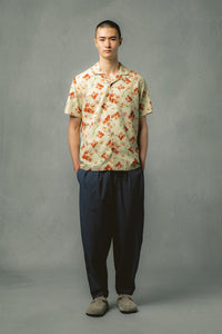 A man wearing a floral shirt and technical trousers from Scottish menswear brand KESTIN.