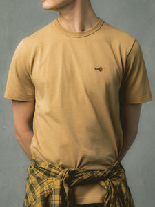 A model wearing a tan brown tee from Scottish menswear designer KESTIN.