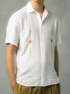 A model wearing the KESTIN Aberlady Shirt in white with celtic embroidery.