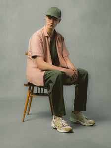 A model sitting down, wearing a spring outfit from menswear brand KESTIN.