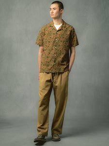 A man wearing a short sleeve shirt and chinos from menswear designer KESTIN.