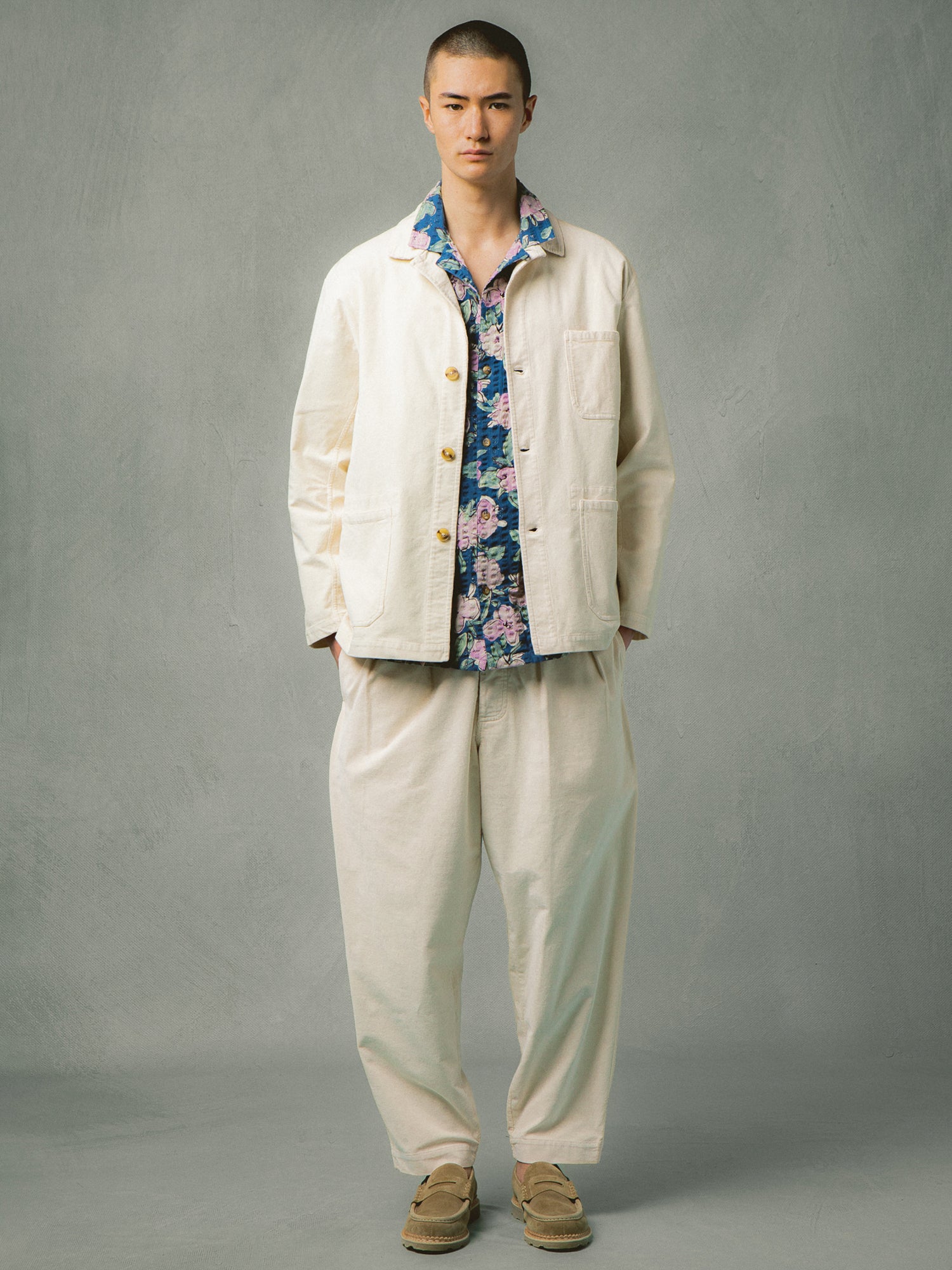 A man wearing a blue floral shirt with a cream corduroy suit from Kestin Hare.