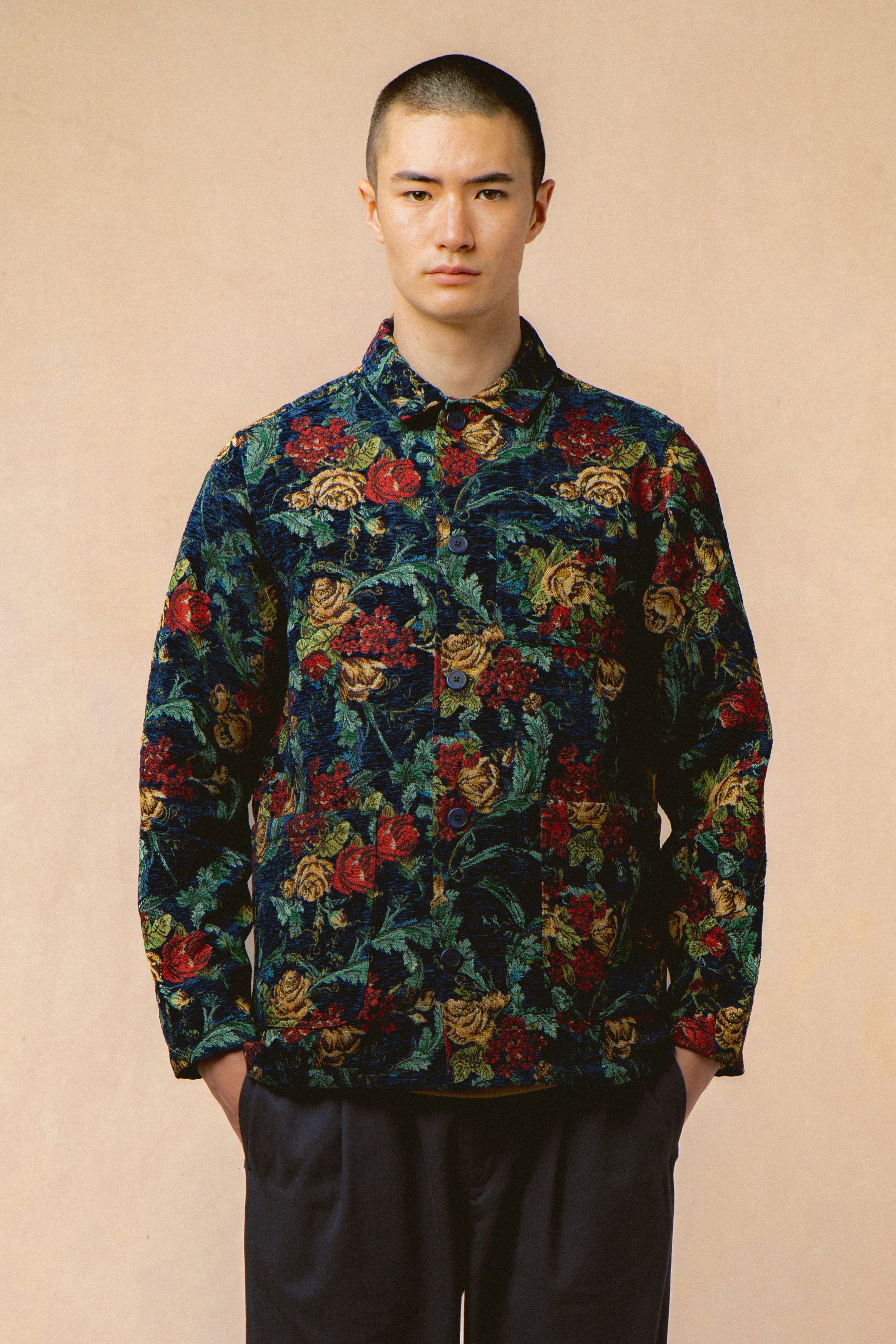 A model wearing a navy blue floral jacket from menswear designer KESTIN.