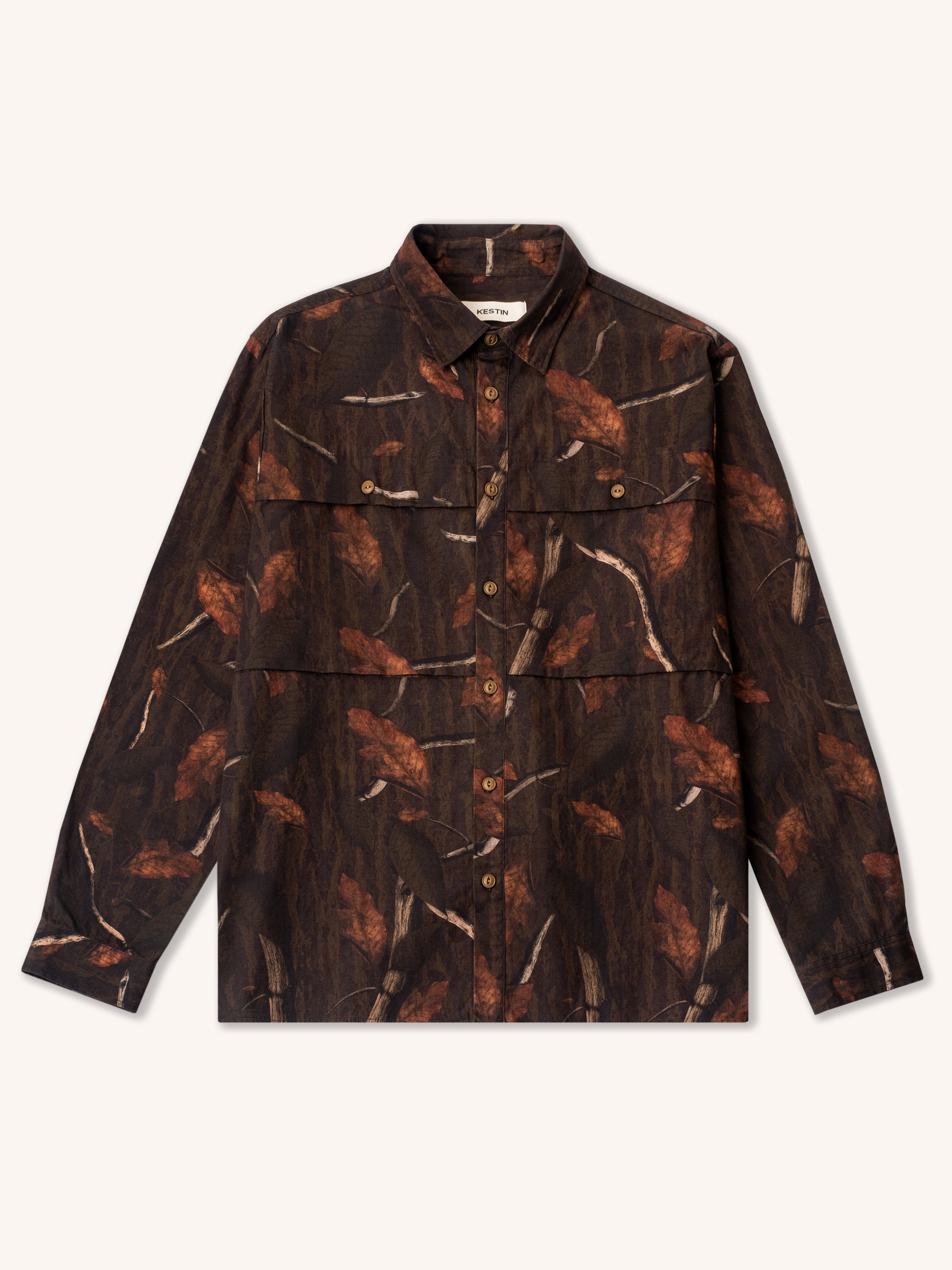 An overshirt with two large pockets and a leaf camo print.