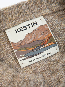 A woven neck label with mountain graphics, used by menswear brand KESTIN.