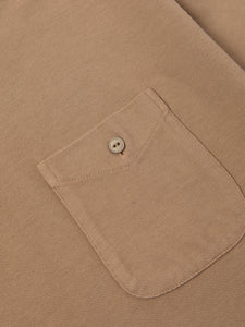 The chest pocket of the KESTIN Dunn Polo Shirt in tan brown.