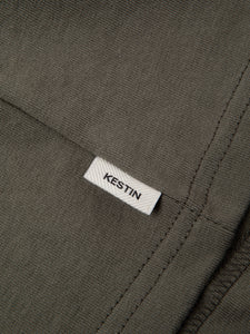 The flag label featuring a KESTIN logo, to the side of the Fly Tee.