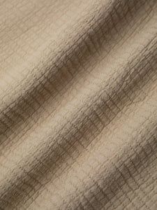 A textured khaki fabric with matchstick stitching, used by menswear designer KESTIN.