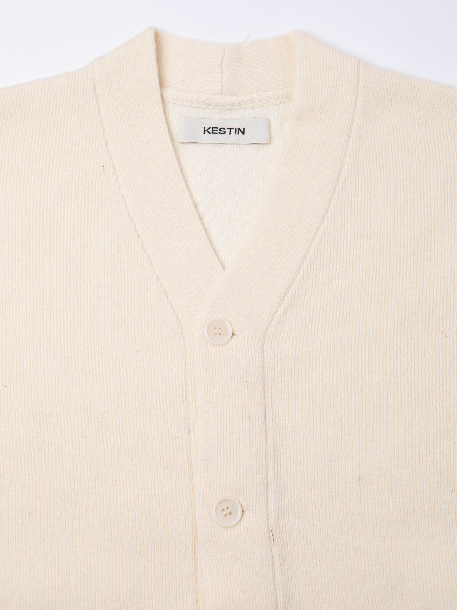 The buttoned front and neckline of the KESTIN Glencorse Cardigan.