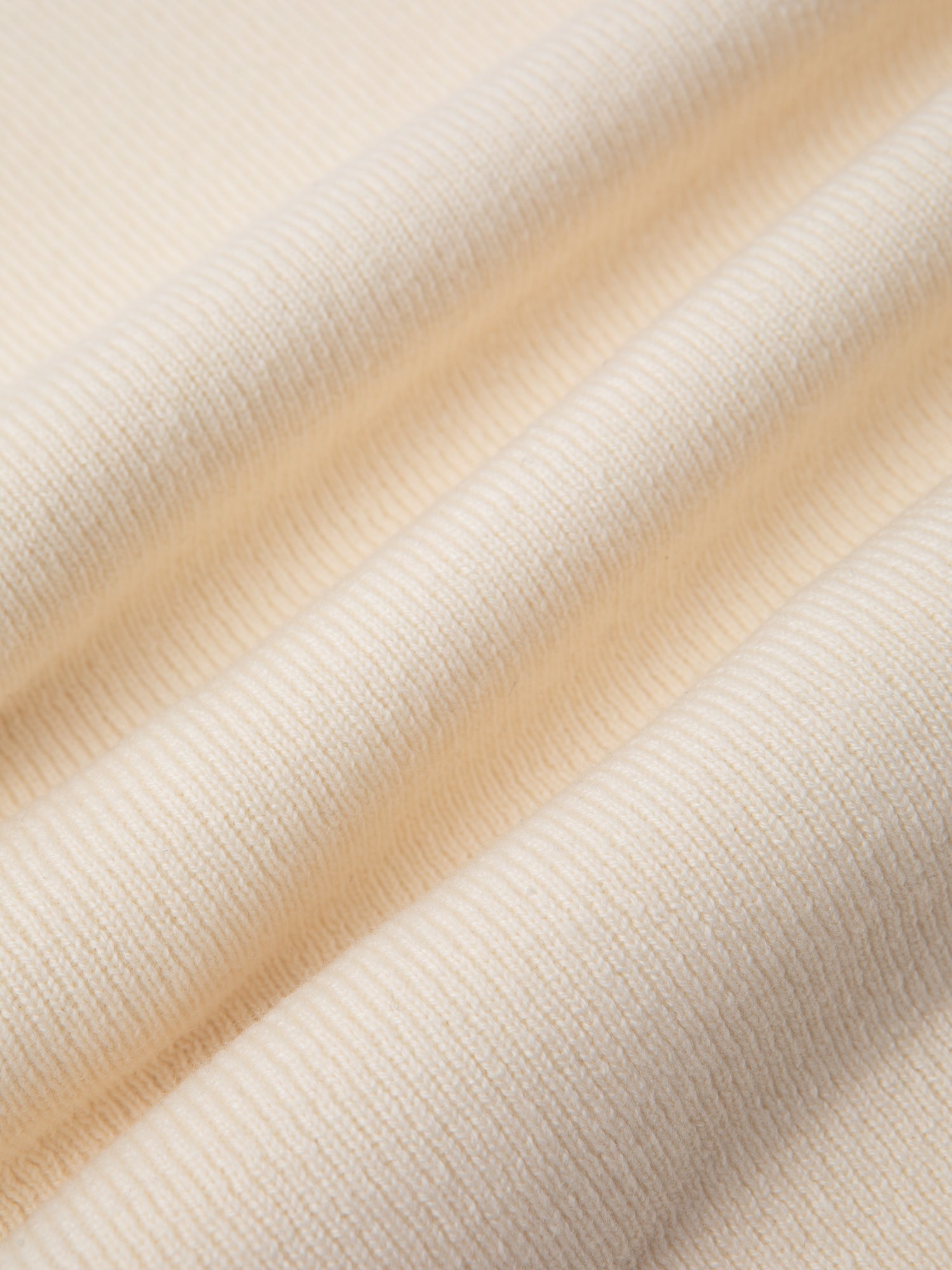 A knitted fabric in ecru white, used to make the KESTIN Glencorse Cardigan.