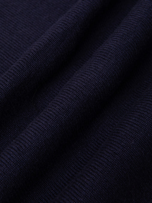 A knitted navy blue fabric used to make the KESTIN Glencorse Cardigan.