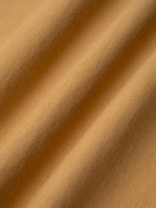 A tan brown t-shirt fabric, used in the KESTIN SS25 Collection.