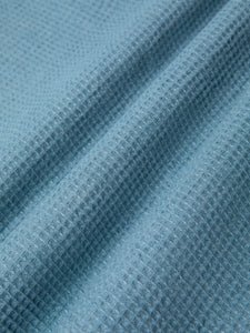 A linen waffle fabric dyed in light blue, used to make the KESTON Ormiston Jacket.