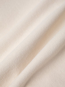 An ecru fine corduroy fabric, used to make KESTIN Trousers.