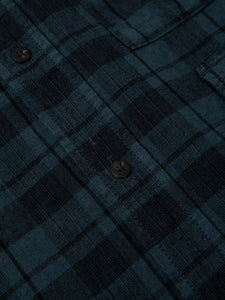 A cotton and linen blend fabric, overdyed in a petrol blue check pattern.