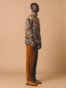 A man wearing a pullover wool fleece and corduroy trousers by designer brand KESTIN.