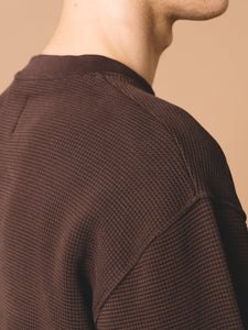A model wearing the KESTIN Humbie Sweatshirt, made from a comfortable cotton waffle knit.
