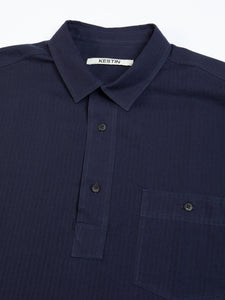 The buttoned collar and chest pocket of the KESTIN Granton Shirt, which is a pop-over workwear shirt.